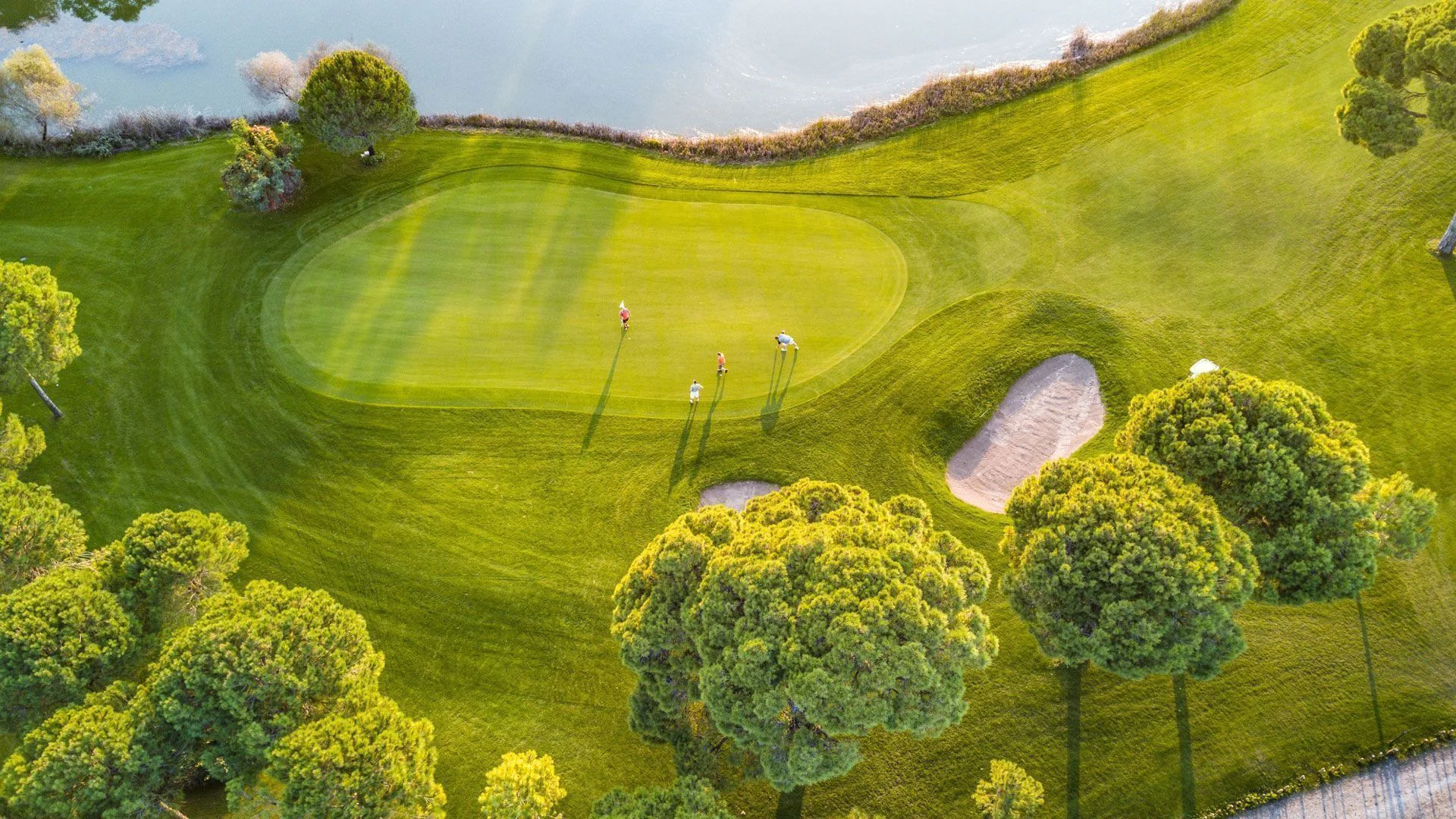 The lake-side 27th green on the Faldo-designed course at Cornelia Golf Club