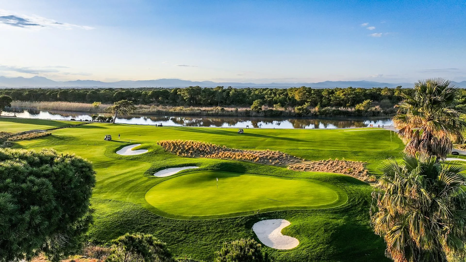 The Aspendos Course at Cullinan Links with a lake-side green framed by pine trees
