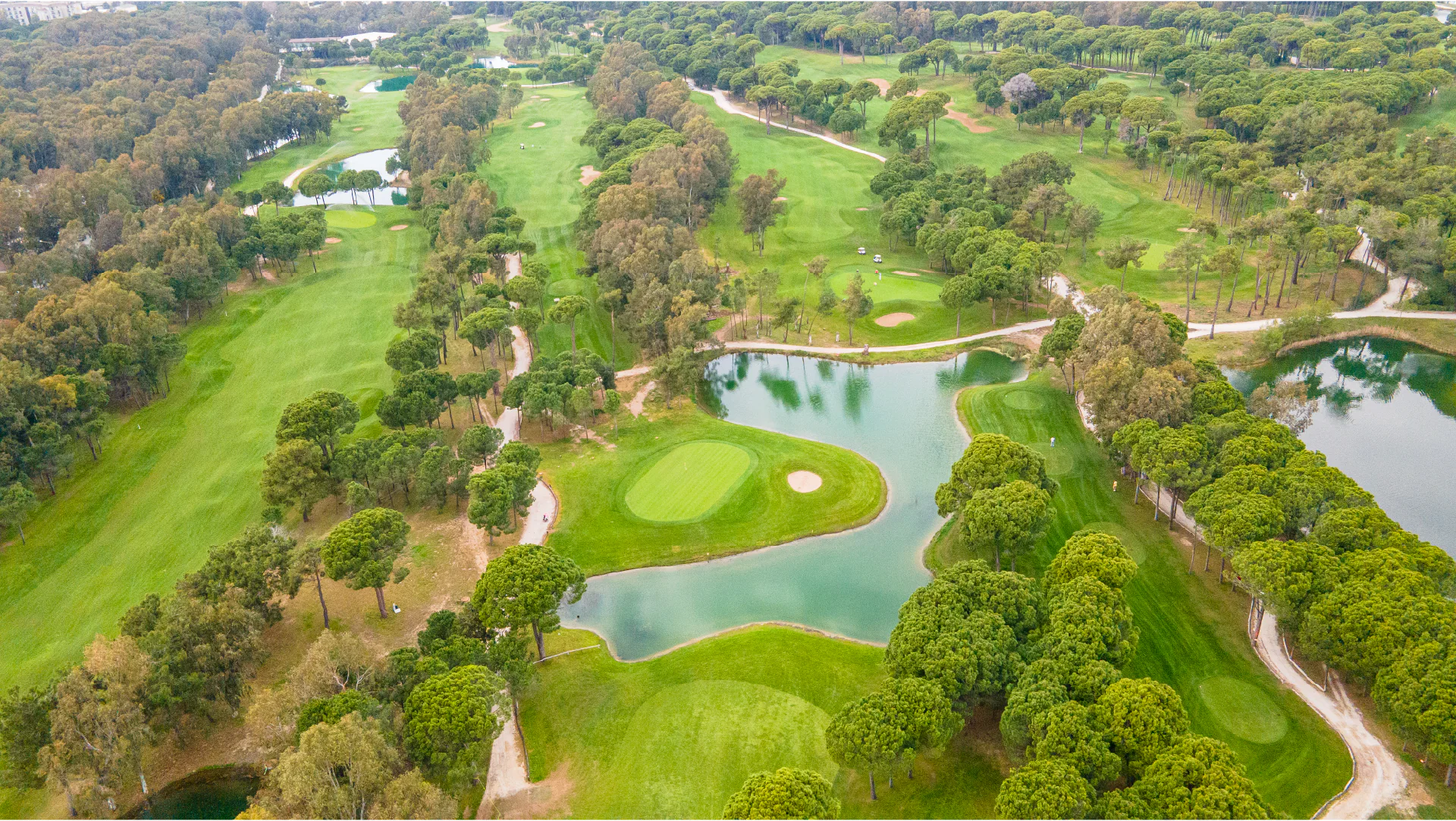 Aerial view of the Sueno Dunes Course with lakes, greens and tree-lined holes