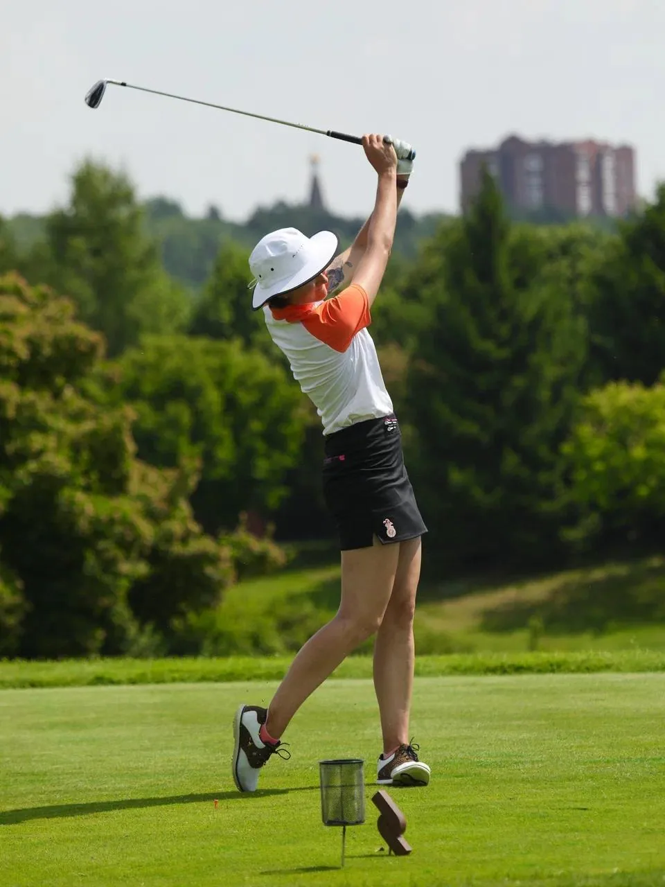 Aleksandra Chekalina completing a driver swing on the tee