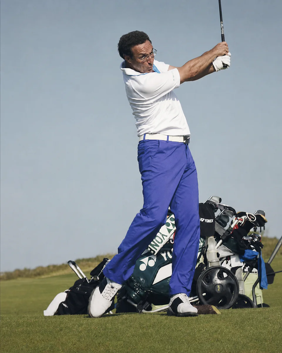 Mahmut Baran completing a golf swing on the practice range