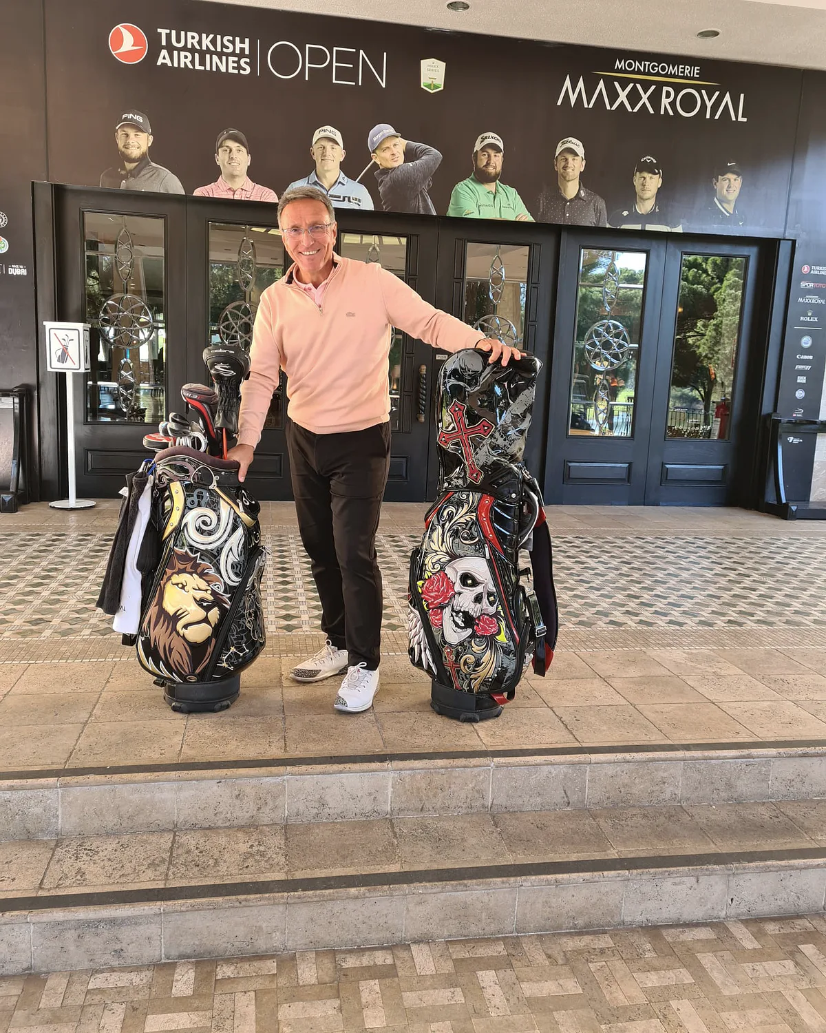 Mahmut Baran beside two golf bags